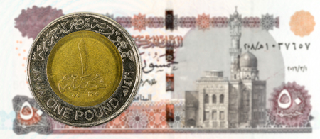 1 egyptian pound coin against 50 egyptian pound bank note full frame obverseの写真素材