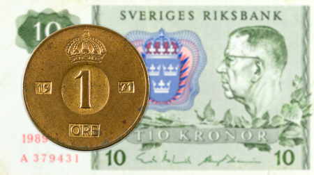 1 swedish oere coin against 10 swedish krona noteの写真素材
