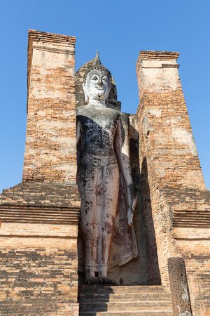huge standing Buddha sculpture in Wat Mahathat in the Historical Park of Sukhothai, Thailand, Asiaのeditorial素材