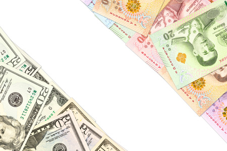 some thai baht and us-dollar banknotes indicating trade relations with copyspaceの写真素材