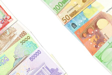 some Uzbek Som banknotes and Euro banknotes indicating bilateral economic relations with copy spaceの写真素材