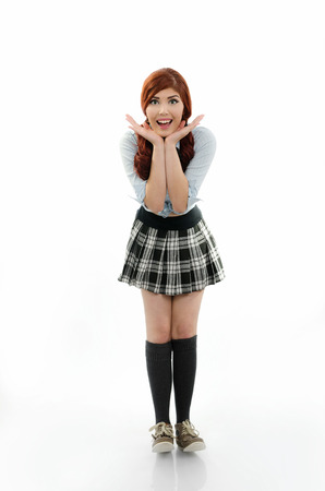 Happy schoolgirl with hands under chinの写真素材