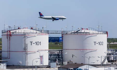 Plane Landing close to fuel storage tanks at Vienna International Airport