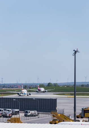Planes lined up ready for take off at Vienna International Airportのeditorial素材