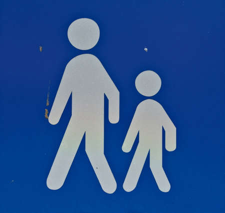 Pedestrian sign with child and an adult in white on a blue background. Often signals a school road ahead.の写真素材