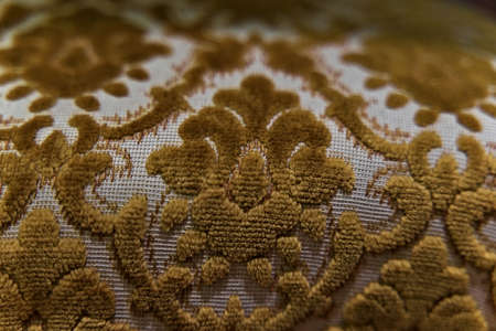 Close-up of old Victorian furniture fabric weave in gold and brown.の写真素材
