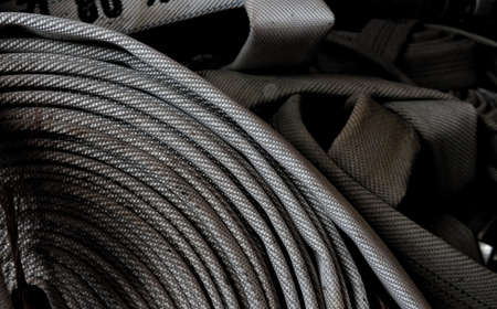 Fire fighter hose rolled up and ready for action. Close-up.の写真素材