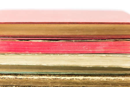 Pile of old vintage books isolated on white background