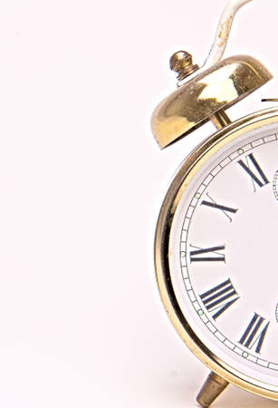 Old alarm clock with classic letters one half isolated on white background.