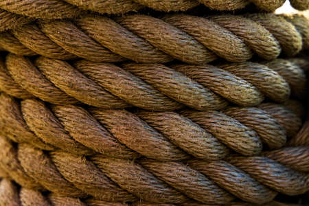 Close up of thick marine grade hemp rope coiled in multiple layers.