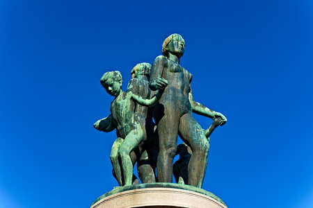 Bronze statue with green patina, resemblance of women and children dancing naked.の写真素材