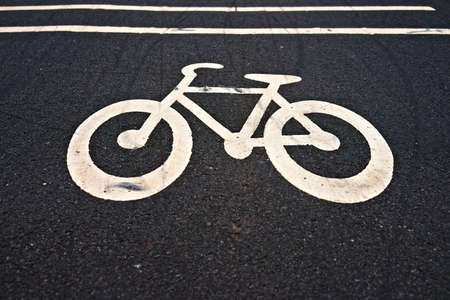 Urban bike path icon on dark asphalt. . High quality photoの写真素材