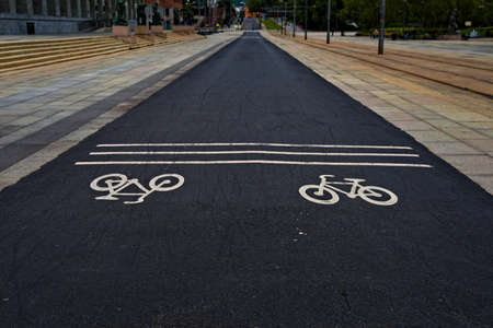 Urban bike path with icons on the asphalt. . High quality photo