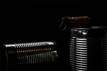 Two used simple tin cans with curled lids, isolated on black background. . High quality photoの写真素材