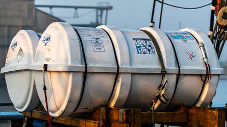 Modern life raft in its white canister in the deck of a ship ready for deployment. High quality...