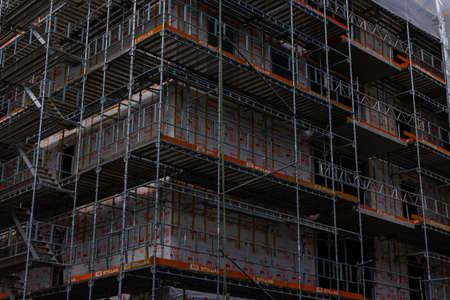 Scaffolding on a construction site building new urban apartments. .の写真素材