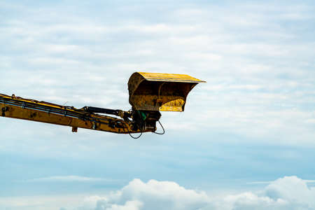 Hydraulic arm and shovel scoop of a large excavator working at a construction site. . High quality photoの写真素材