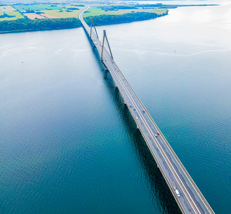 Large suspension highway bridge with cars and trucks passing. Faroe bridge aerial view. . High...