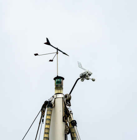 Top of the mast of a sailboat with wind indicator, lanterns, antennas and other instruments. High quality photoの写真素材