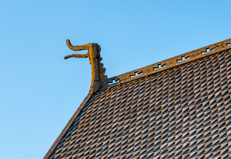 Detailed wooden carvings of dragon heads and crosses on a medieval wooden stave church built by Vikings. . High quality photoの写真素材