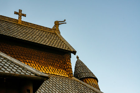 Detailed wooden carvings of dragon heads and crosses on a medieval wooden stave church built by Vikings. . High quality photoの写真素材