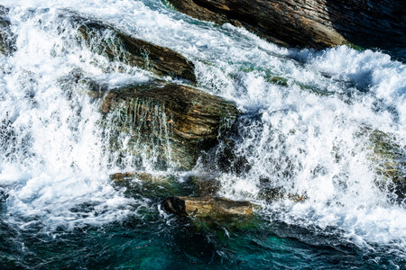 Wild and fast moving river rapids white water rushing over rugged cliffs. Close up. . High quality photoの写真素材
