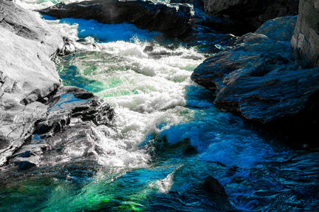 Wild and fast moving river rapids white water rushing over rugged cliffs. Close up. . High quality photoの写真素材