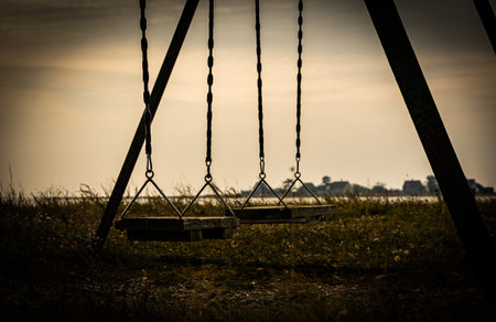 Old weathered swing made from wood planks, looking desolate. . High quality photoの写真素材