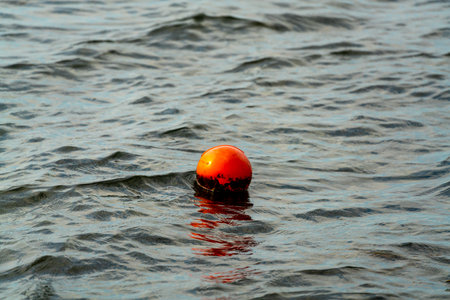Orange buoy marker, marking the location of a crab pod left by a fisherman. . High quality photoの写真素材