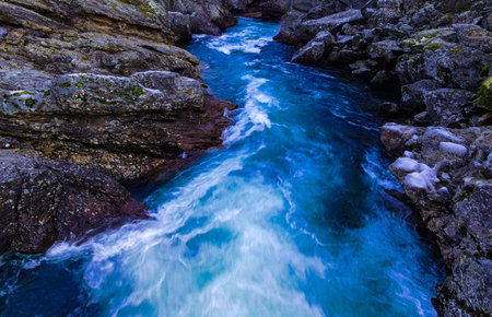 Massive and fast moving water fall in a Norwegian national park. Motion blur.の写真素材