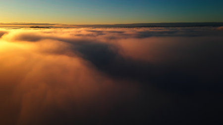 Flight above the clouds into a golden sunset. High quality photoの写真素材