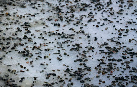 Close up of gravel strewn on an icy road. High quality photoの写真素材