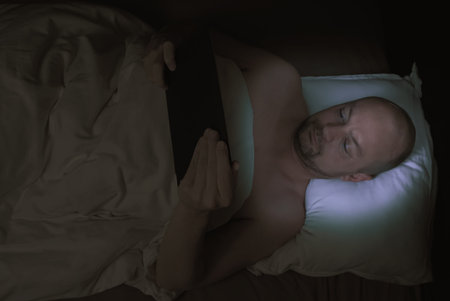 Man lying in bed, stressed cant sleep staring at the ceiling. . High quality photoの写真素材