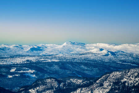 Snowy mountains in the Norwegian wilderness on a cold clear winter evening.の写真素材