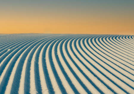 Close up of groomed tracks on a slope in a downhill ski resort.の写真素材