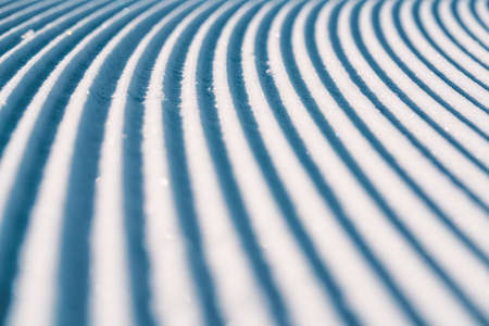 Close up of groomed tracks on a slope in a downhill ski resort.の写真素材
