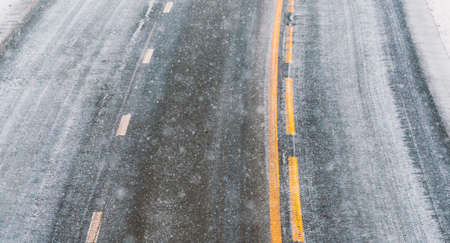 Close up image of road asphalt covered in snow and ice on a cold snowy winters day. High quality photoの写真素材