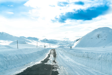 Narrow road through a snow covered mountain pass in the middle of winter. High Quality image.の写真素材