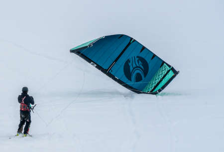 People Snowkiting on a frozen snowy mountain plain on a cold winters day.のeditorial素材