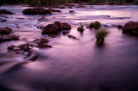 river water in shades of lilac with blurred effect, long exposure.