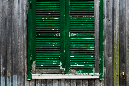Aged rustic wooden background texture in natual color, no paint with older green windowの写真素材