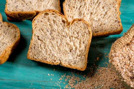 sliced whole bread on textured blue wood