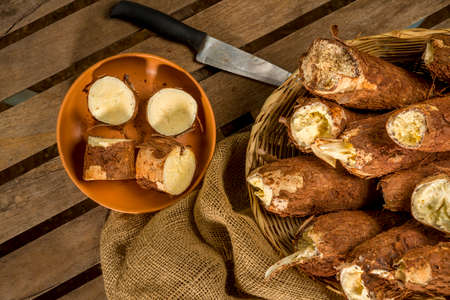basket of freshly harvested manioc with manioc sliced, top view