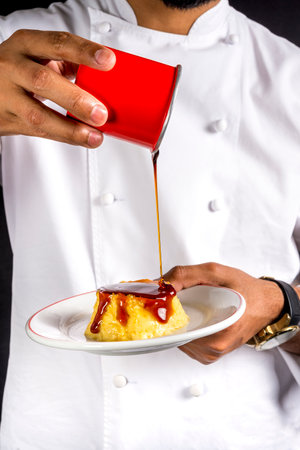 Chef pouring sweet syrup over caramel custard pudding.