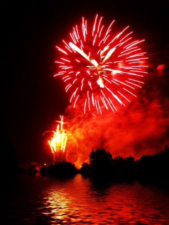 Fireworks and reflection on waterの写真素材