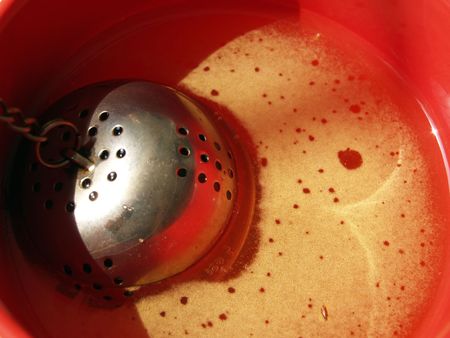 Closeup of a red cup of tea, with swallow DOFの写真素材