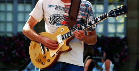 Man playing the guitar in a concert
