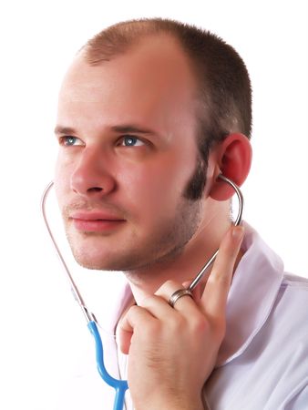 Young doctor using a stethoscope and smilingの写真素材
