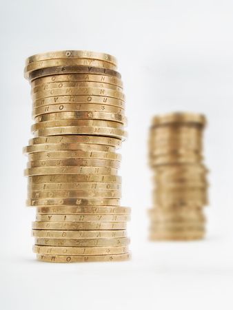 Piles of coins on a white backgroundの写真素材