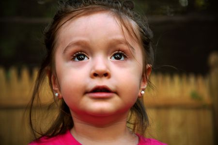 Baby girl looking at the skyの写真素材